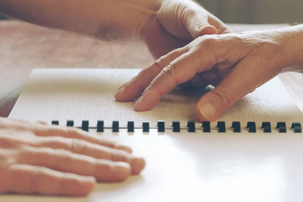 Visually impaired old person learning to reading by touch — Stock Photo, Image