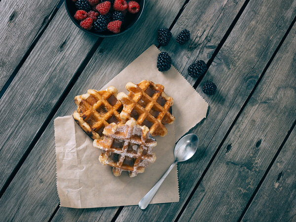 Homemade waffles whit fruits on vintage table.