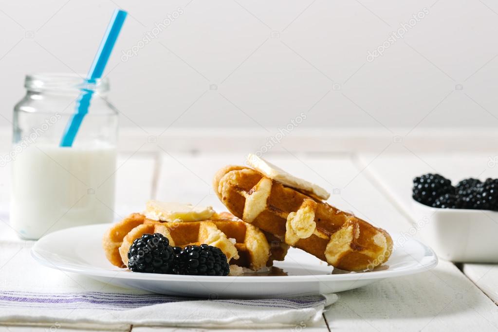 Homemade waffles with fruits on white vintage table