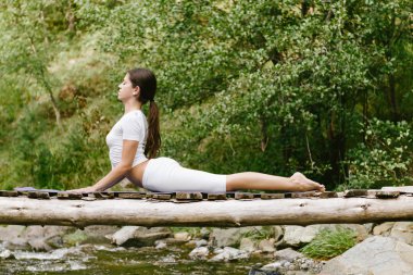 Woman  doing yoga in nature. clipart