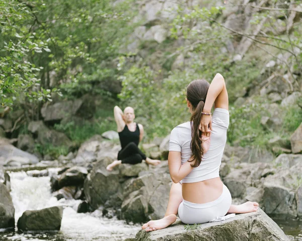 Man and woman doing yoga in nature.. — Stock Photo, Image