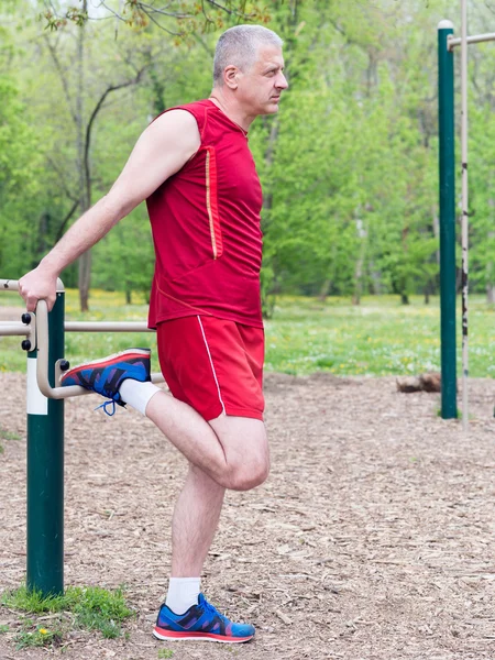 Senior Exercising In Sport Park Stock Picture