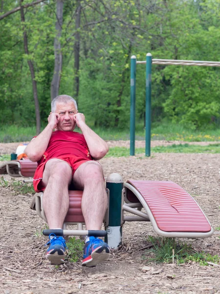 Senior Exercising In Sport Park Royalty Free Stock Photos