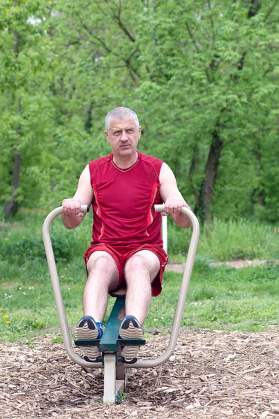 Senior Exercising In Sport Park Royalty Free Stock Photos