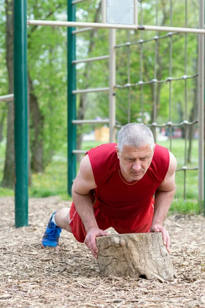 Senior Exercising In Sport Park Stock Image