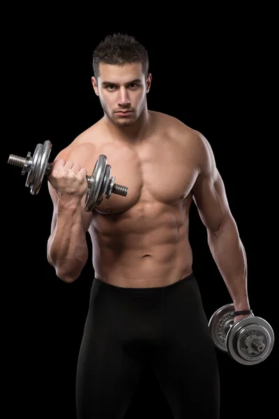 Muscular men exercise with dumbbells. Stock Image