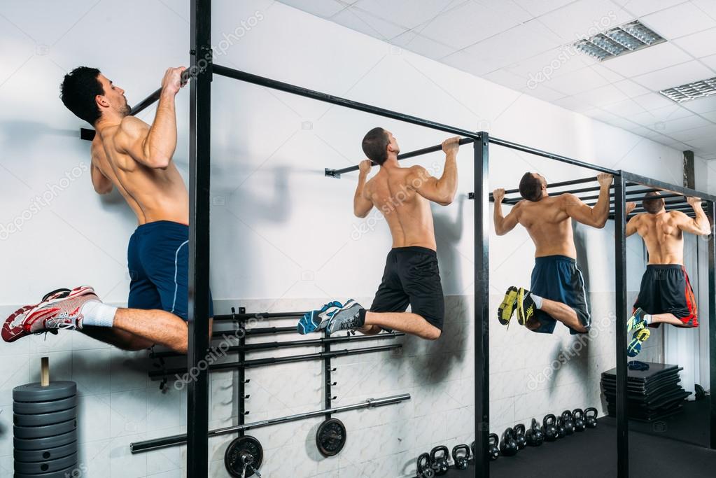 Group of Muscular Men Doing Pull Ups as part of Crossfit Training.