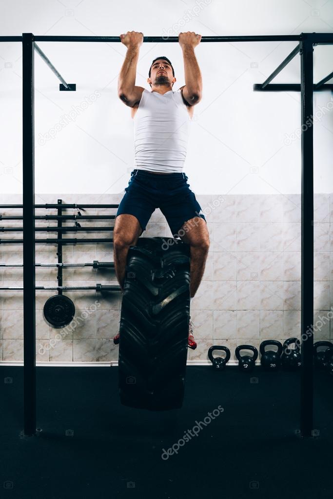 Muscular Men Doing Pull Ups as part of Crossfit Training.