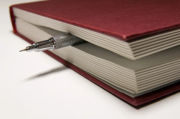 Vörös könyv és mechanikus ceruza belül — Stock Fotó