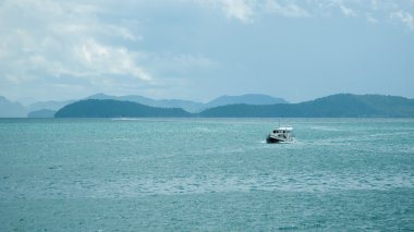 The Boat in the Bay on a Rainy Day. Islands at Phang Nga Bay near Krabi and Phuket. Thailand.