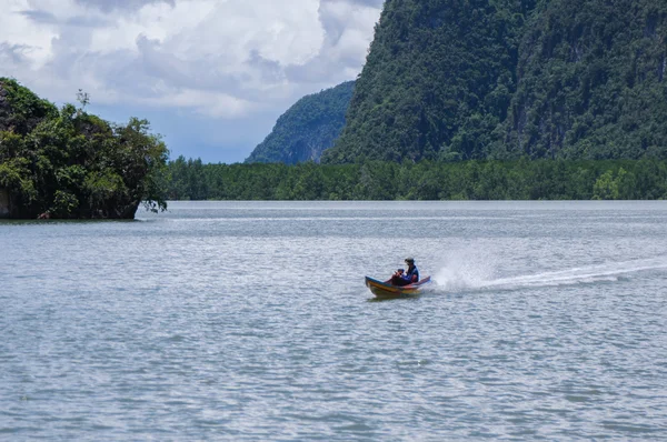 The Boat on the Bay surrounded by Islands with Mangroves. Islands at Phang Nga Bay near Krabi and Phuket. Thailand.