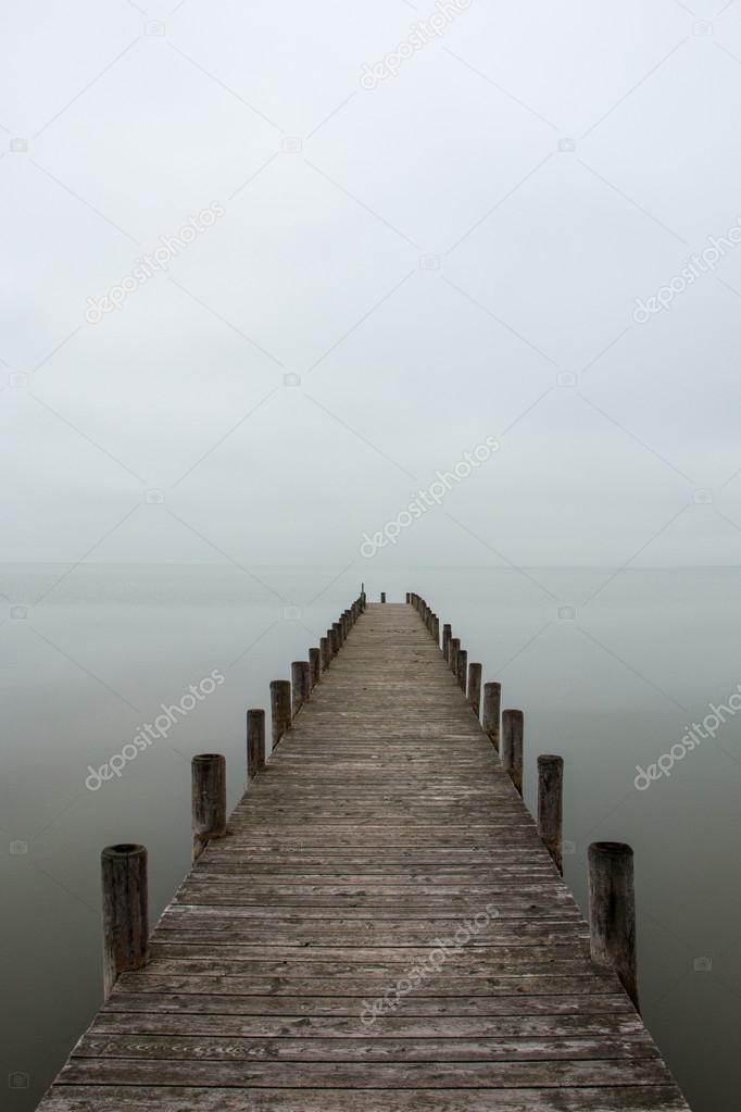 Jetty in foggy weather (vertical)