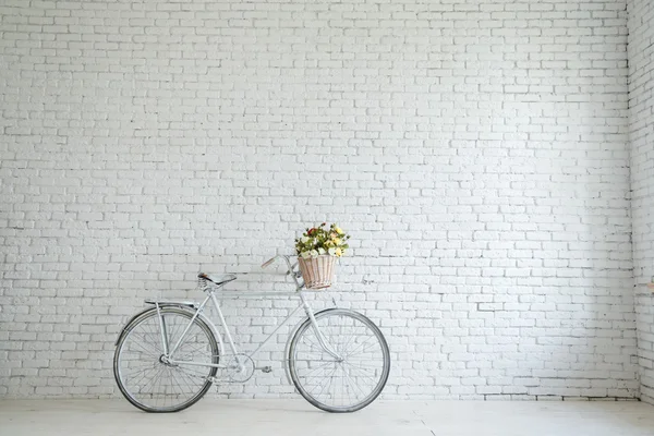 Retro bicycle on roadside with vintage brick wall background