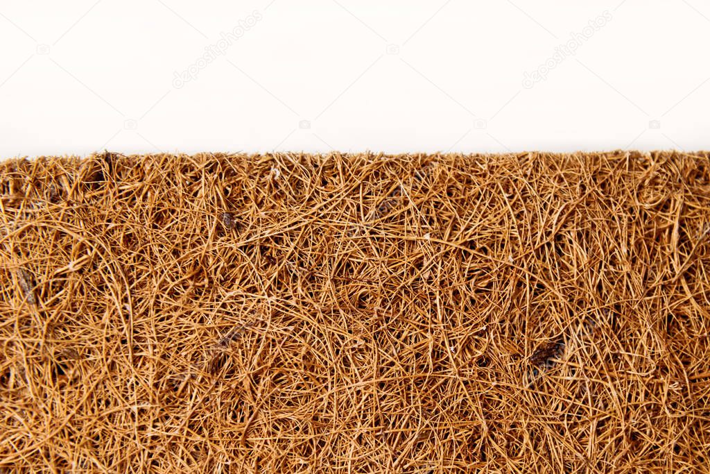 Close-up mattress made of coconut fiber isolated over white.