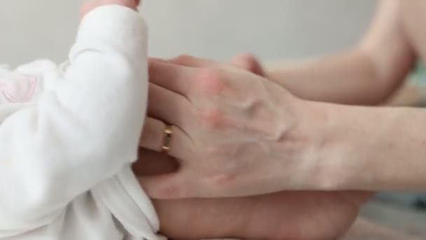 Τα χέρια της μητέρας χαϊδεύουν τα πόδια και το σώμα του βρέφους με αγάπη. Κοντινό μασάζ ποδιών μωρού. Air Bath μετά πάνες — Αρχείο Βίντεο