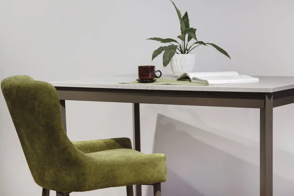 Modern minimalist workplace. Green velours armchair and loft table with home plant in white pot — Stock Photo, Image