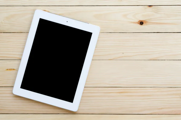 Wooden desk with  tablet computer — Stock Photo, Image