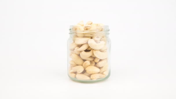 Stop Motion Animation Cashew Nuts Glass Jar White Background — ストック動画