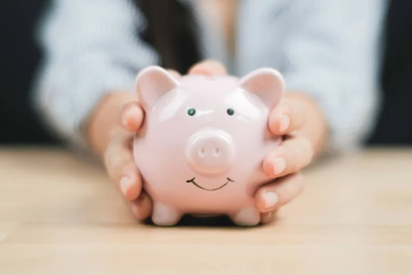 Saving Money Concept Women Hand Hold Piggy Bank Wooden Table — Foto de Stock
