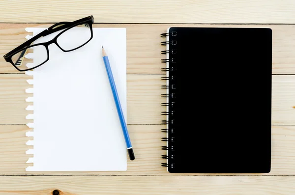 Kara defter ve kalem ve gözlük ile boş kağıt — Stok fotoğraf