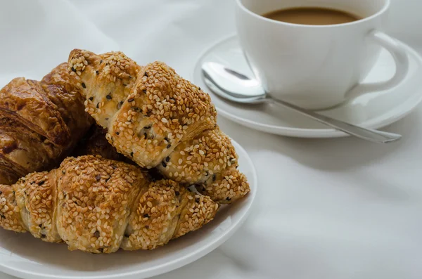 Sesam-Croissant und heißer Kaffee zum Frühstück. — Stockfoto