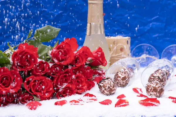 Candies Snow Bouquet Red Roses Blue Background Next Bottle Champagne — Stock Photo, Image
