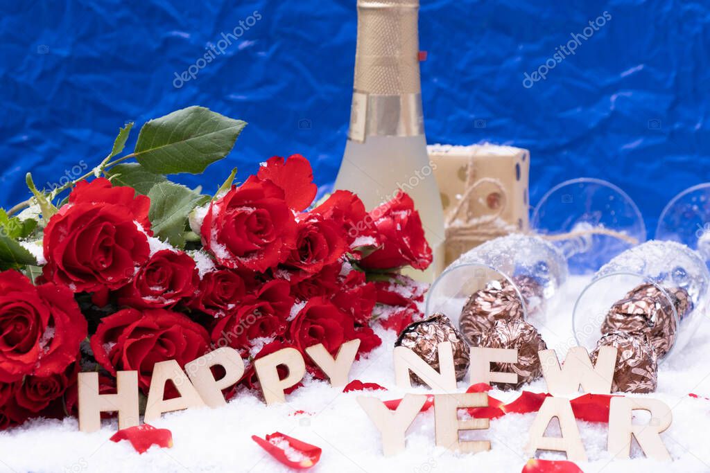 a bouquet of red roses on a blue background, next to a bottle of champagne and the inscription 