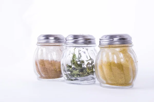 Glass jars of different spices — Stock Photo, Image