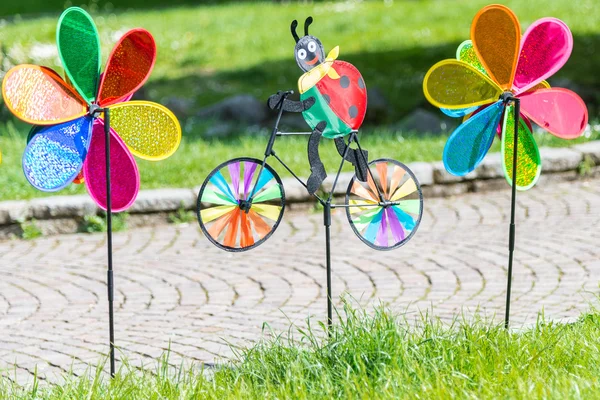 Three colorful pinwheels on grass — Stock Photo, Image