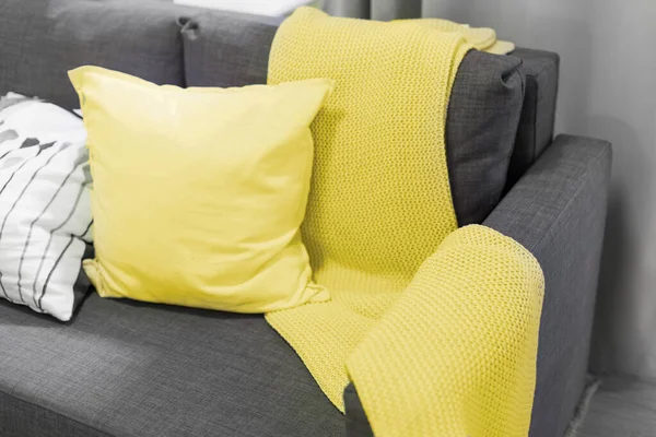 Color of the year 2021. blanket and pillows on the sofa in the interior.