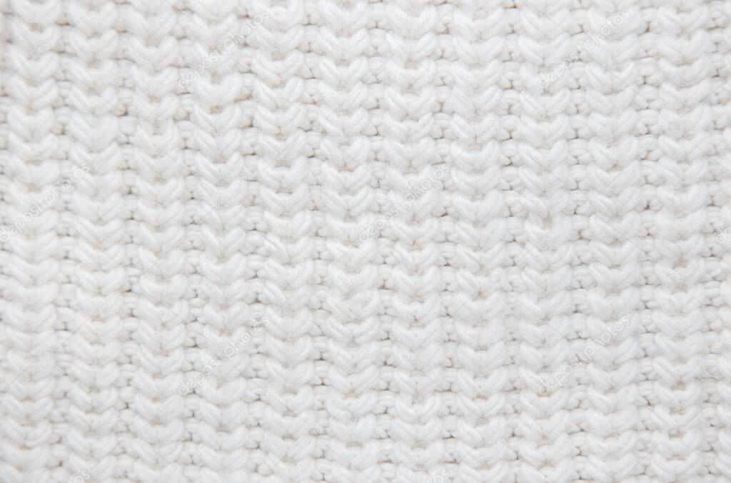 White knitted fabric texture. Wool background.