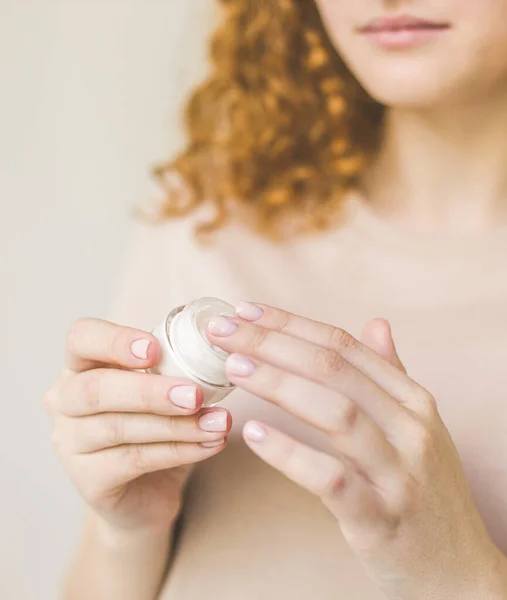 Young skin care concept. Hands of a woman about to apply face cream. — Stock Photo, Image