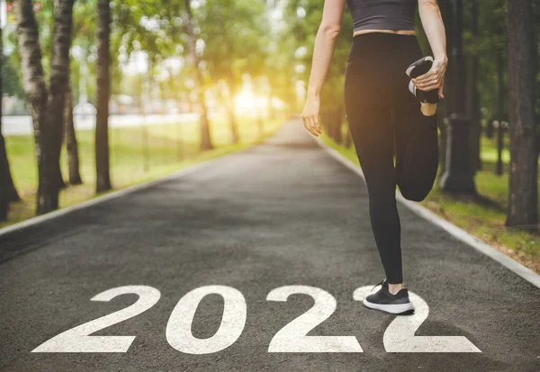 Frauenfüße in Turnschuhen am Start. Beginn und Beginn des neuen Jahres 2022, Ziele und Pläne für das nächste Jahr — Stockfoto