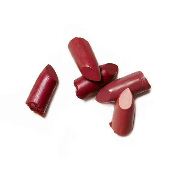 Red broken and crumbled lipsticks — Stock Photo, Image