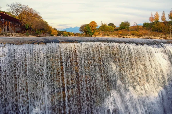 Autumn landscape with river and waterfall. Cijevna river waterfall.  Montenegro, Podgorica