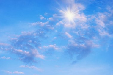 White clouds in blue sky with light from sun.  Cirrocumulus clouds