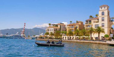 Tivat, Montenegro - June 01, 2025:  View of embankment of Tivat city and Porto Montenegro marina on sunny summer day. Tivat city, Montenegro