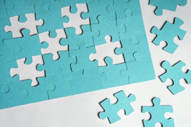 Jigsaw puzzle with missing pieces and pieces to complete  solution. Concepts of solving problem. Copy space