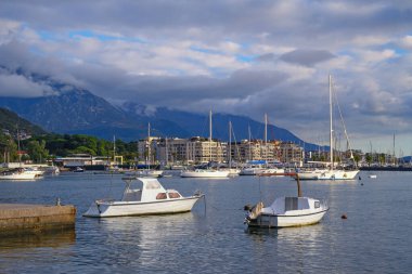 Beautiful  Mediterranean landscape on cloudy autumn day. Montenegro, Adriatic Sea. View of Bay of Kotor and city of Tivat. Sailboats and fishing boats on water