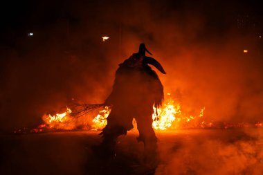 Krampus alevlerin ortasında, dinsel folklor figürüne eşlik eden şeytani bir varlık var. Bu gelenek Hıristiyan mitolojisine bağlıdır..