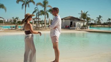 Kumsaldaki havuzda mutlu bir çift