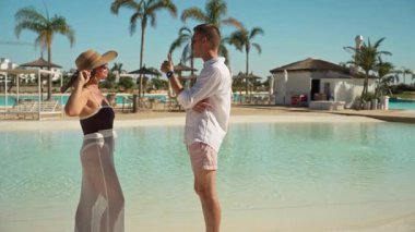 Kumsalda aşık mutlu genç bir çift. Yaz tatili. Genç adam ve kadın sahilde. Birbirlerine aşık çiftler tatilde..