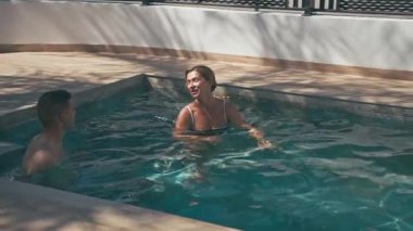 Yaz boyunca yüzme havuzunda içki içen çift.