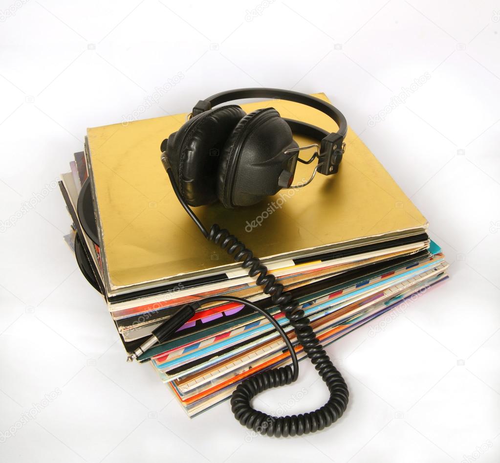 Vintage headphones on a stack of old vinyls 