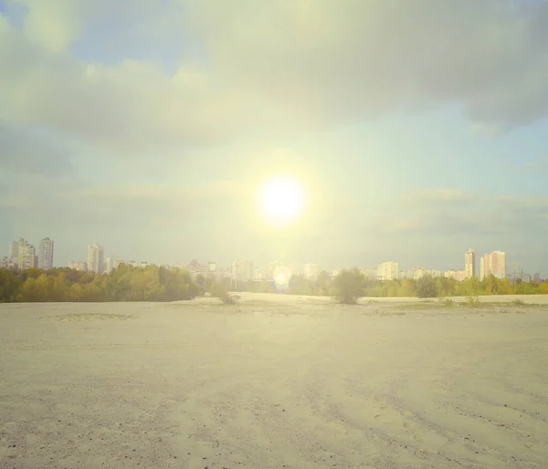 The yellow sun shines over the desert and the city. Landscape of beautiful africa
