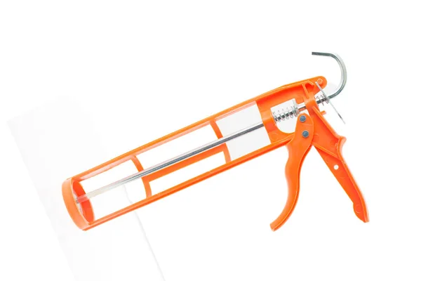 白い背景とテキストのためのスペースに隔離されたオレンジ色のコーキングツール — ストック写真