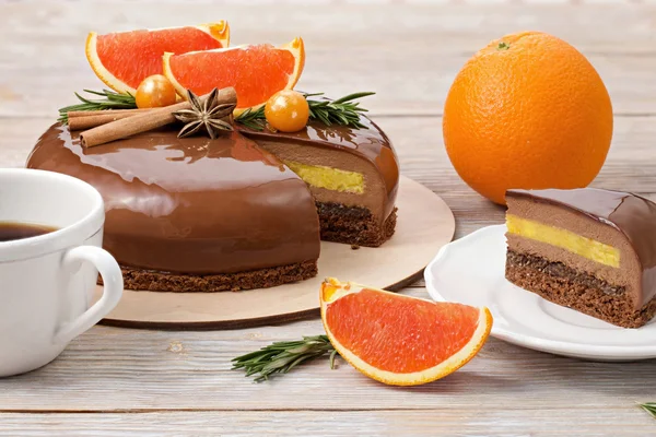 Chocolate mousse cake and slice of cake with red oranges