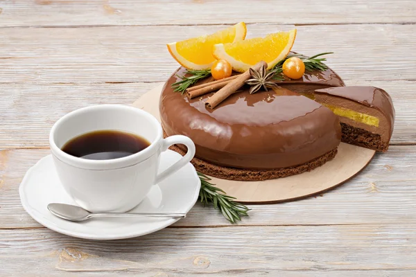 Chocolate mousse cake with oranges and a cup of coffee