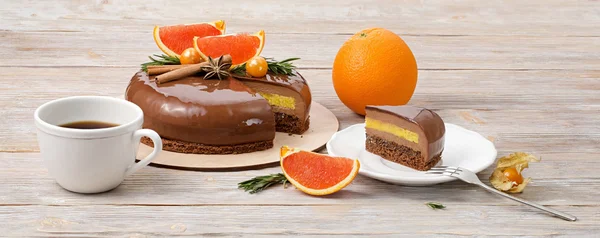 Chocolate mousse cake and slice of cake with red oranges
