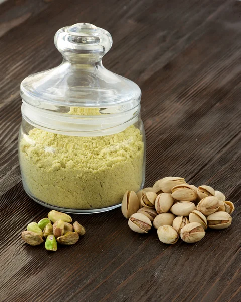 Pistachio flour in jar and nuts — Stock Photo, Image